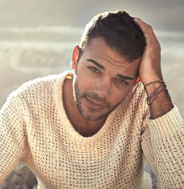 attractive man posing with hand in his hair